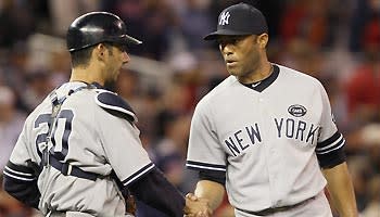 Jorge Posada (left) congratulates Mariano Rivera after closer posted a four-out save