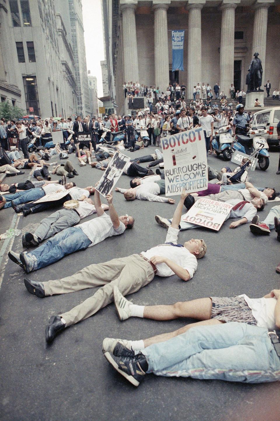 In this Thursday, Sept. 14, 1989 file picture, protestors lie on the street in front of the New York Stock Exchange in a demonstration against the high cost of the AIDS treatment drug AZT.