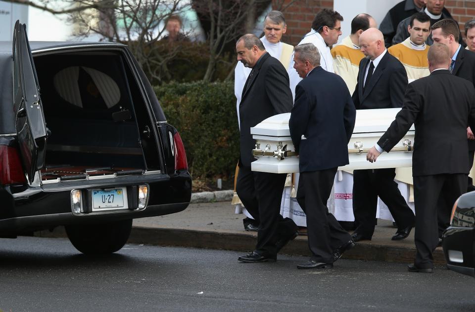 NEWTOWN, CT - DECEMBER 18: A casket carrying the body of shooting victim Jessica Rekos, 6, is brought out after her funeral at the St. Rose of Lima Catholic church on December 18, 2012 in Newtown, Connecticut. Funeral services were held at the church for both Jessica and James Mattioli, 6, Tuesday, four days after 20 children and six adults were killed at Sandy Hook Elementary School. (Photo by John Moore/Getty Images)