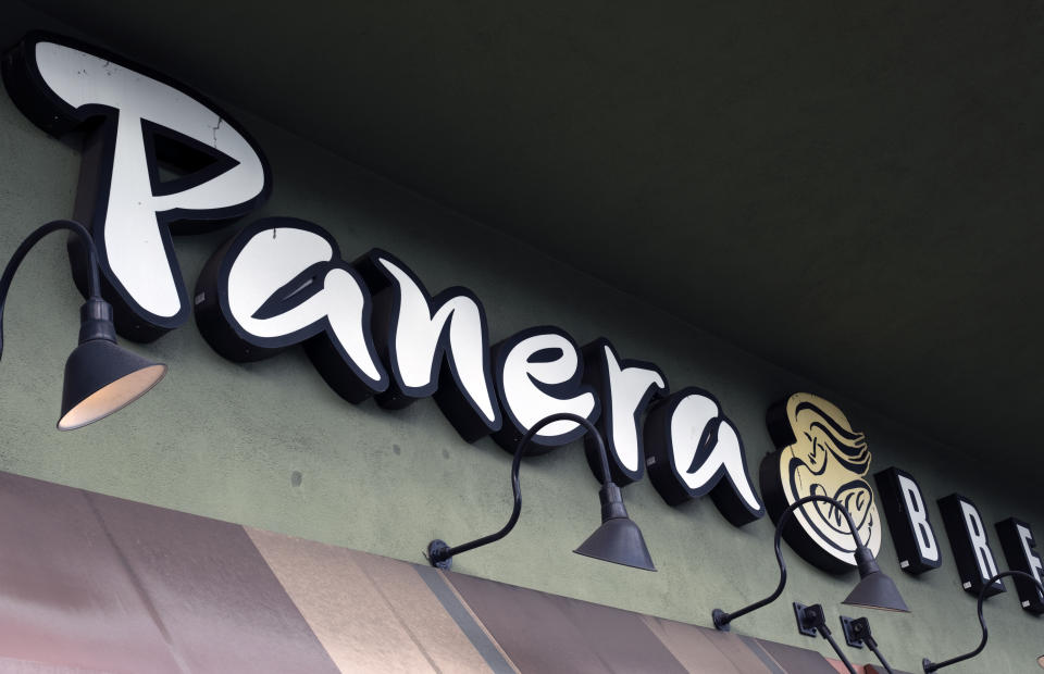 FILE - A Panera Bread sign and logo is attached to the outside of a Panera Bread restaurant location in the Studio City section of Los Angeles, Thursday, March 7, 2024. As California prepares to enforce a new $20-per-hour minimum wage for fast food workers in April 2024, an unusual exemption for eateries that bake their own bread has come under scrutiny due to allegations it was initially intended to benefit a wealthy donor to Democratic Gov. Gavin Newsom's campaign. (AP Photo/Richard Vogel, File)