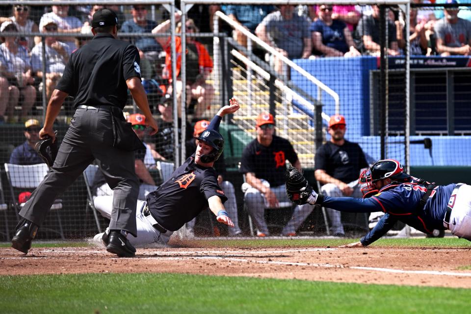 Atlanta Braves catcher Travis d'Arnaud (16) tags out Detroit Tigers shortstop Ryan Kreidler (32) in the third inning of the spring training game at CoolToday Park on March 5, 2024, in North Port, Florida.