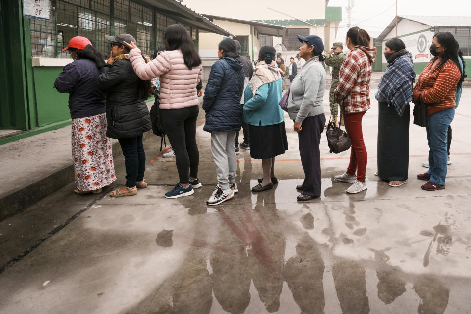 Voters line up at a polling station during a snap election in San Miguel del Comun, Ecuador, Sunday, Aug. 20, 2023. (AP Photo/Dolores Ochoa)