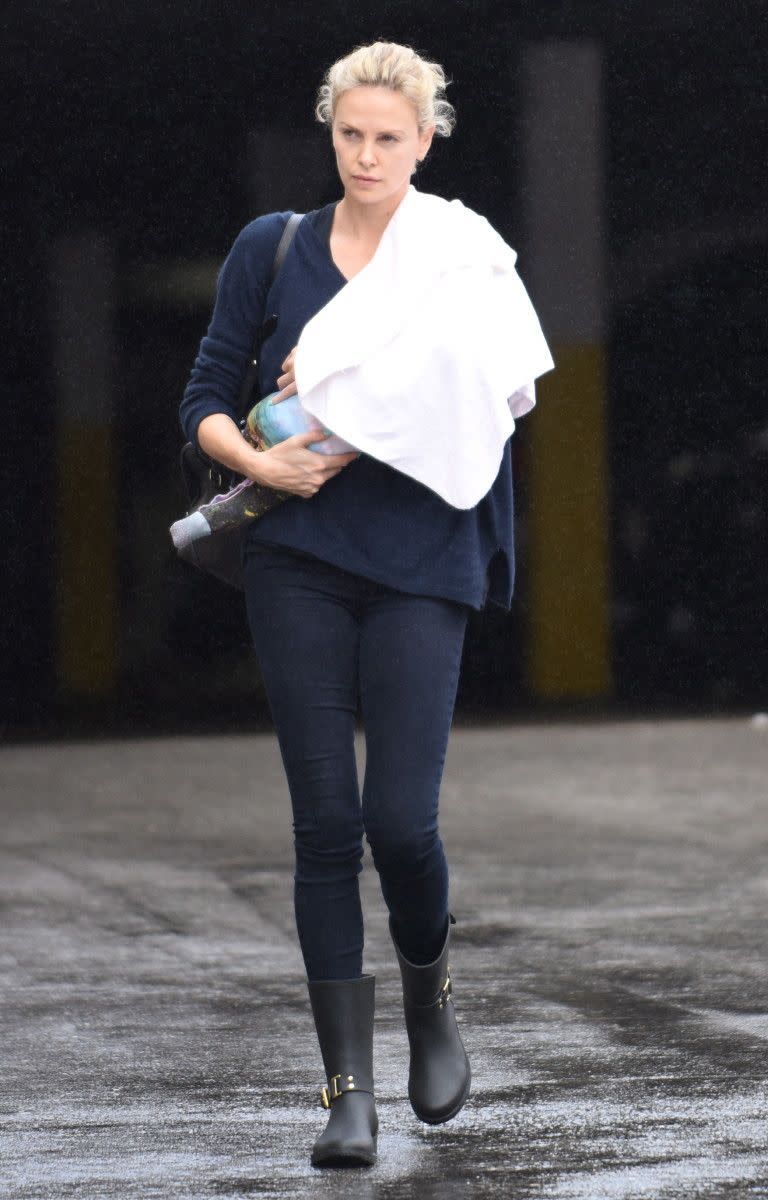 The Theron family is growing! Charlize Theron stepped out for the first time with newly adopted daughter August in the Los Angeles rain on Sept. 15, 2015. Theron adopted her second child in July, according to reports, and already has one adopted son, Jackson.