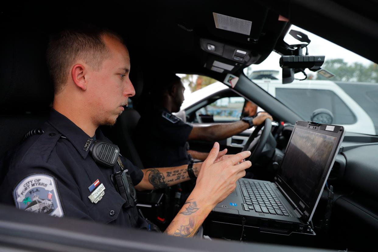 Members of the Fort Myers Police department, from left, Anthony Townsend, officer trainer, and Ian McMillion, officer in training, confer with fellow officer H. Otzoy during a response call on Friday, July 28, 2022.
