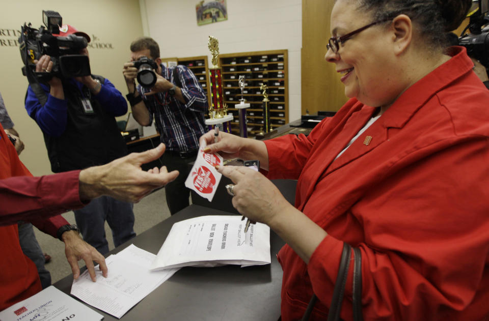 Chicago Teachers Union President Karen Lewis gets a sticker after casting her ballot during a strike authorization vote at a Chicago high school Wednesday, June 6, 2012. Lewis says union members don't want to disrupt the start of the next school year with a strike, but she says they feel voting to authorize one is needed to negotiate a better contract. (AP Photo/M. Spencer Green)