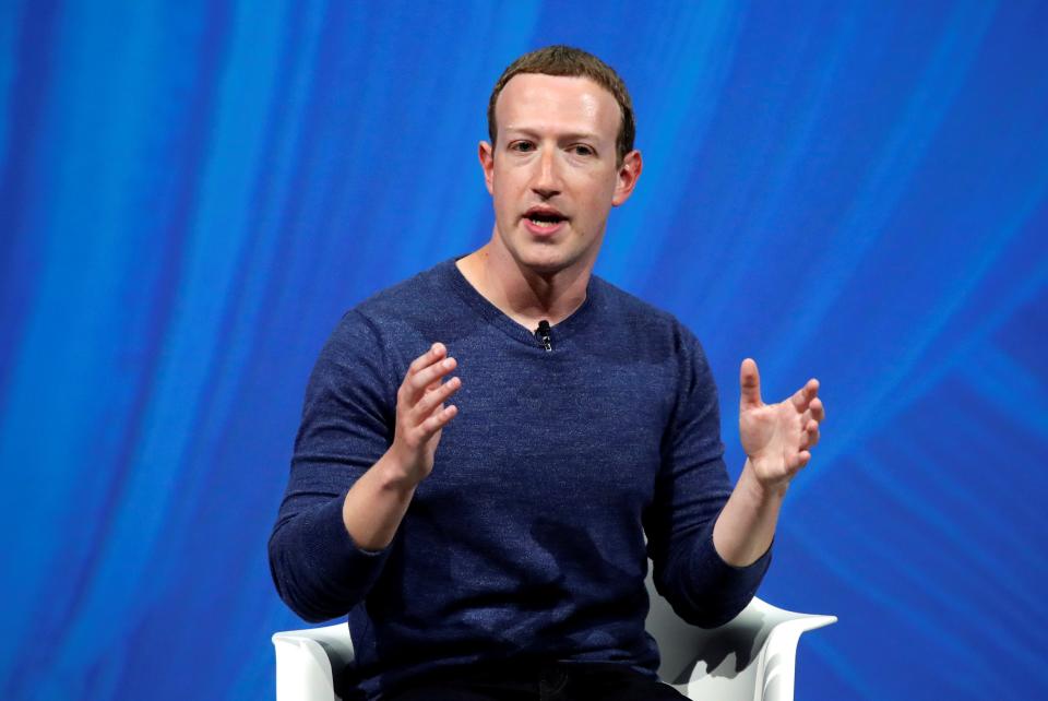 Mark Zuckerberg speaks on stage against a blue background.