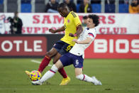 United States' Paxten Aaronson, right, defends against Colombia's Juan David Mosquera during the first half of an international friendly soccer match Saturday, Jan. 28, 2023, in Carson, Calif. (AP Photo/Marcio Jose Sanchez)