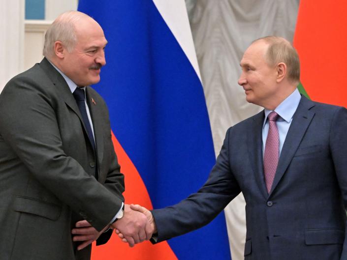 Russia&#39;s President Vladimir Putin (R) shakes hands with his Belarus counterpart Alexander Lukashenko (L) following their talks at in Moscow on February 18, 2022.