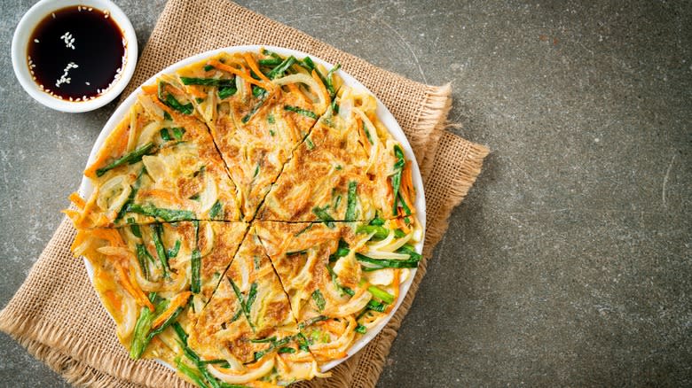 Seafood pancake and dipping sauce on table