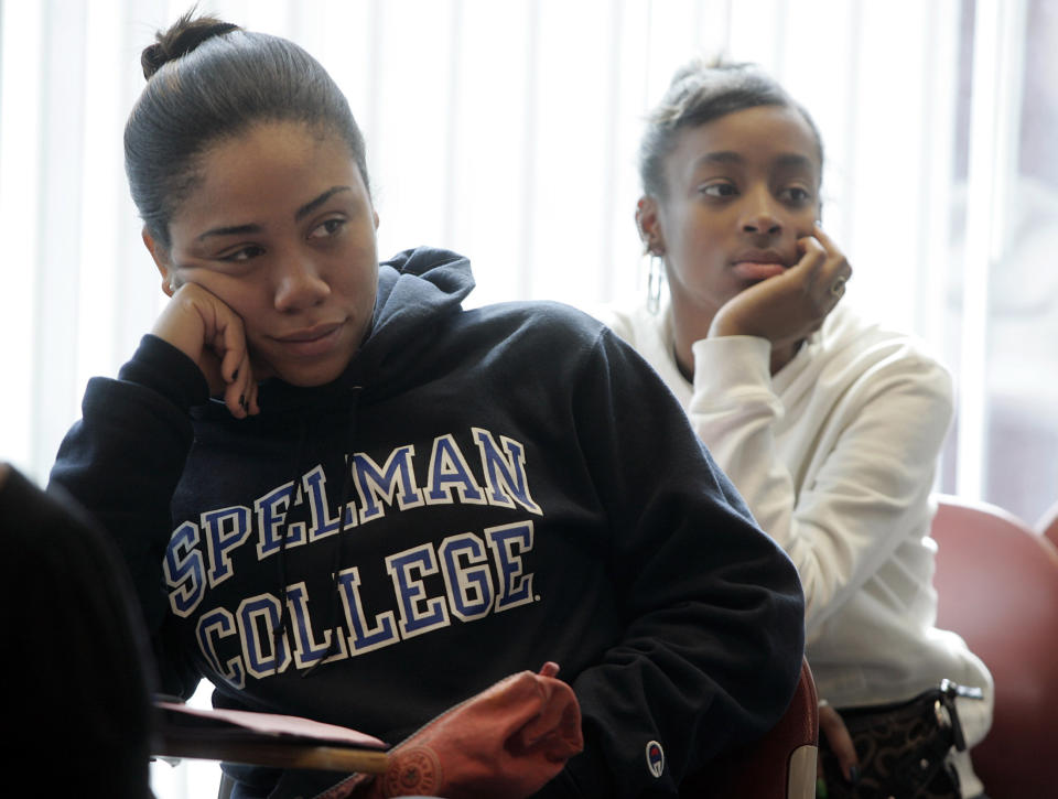 Freshman students Laurah Pollonais (L) and Dalicia Barker listen during a class at Spelman College in Atlanta, Georgia in this picture taken February 12, 2009. Black colleges in the United States are reeling from the impact of a recession that has hit their funding and are struggling to retain poor and middle income students. Picture taken February 12. To match feature USA-UNIVERSITIES/BLACK   REUTERS/Tami Chappell (UNITED STATES)