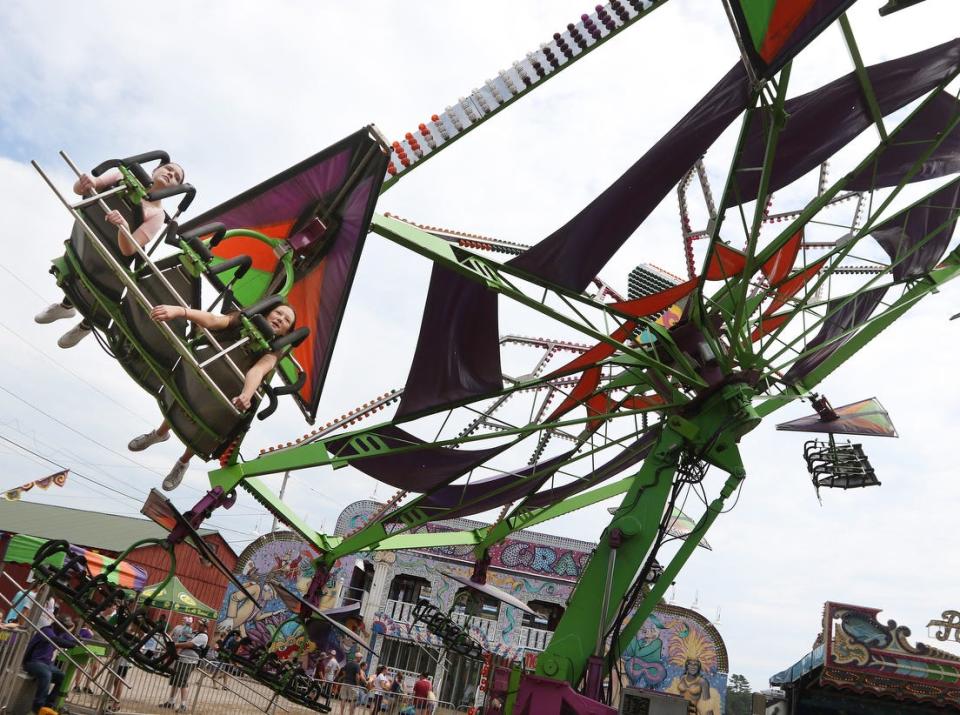 Emma Leather, left, and Jarrah Desjarlais  of Warwick enjoy the Cliff Hanger ride at the 2021 Washington County Fair.