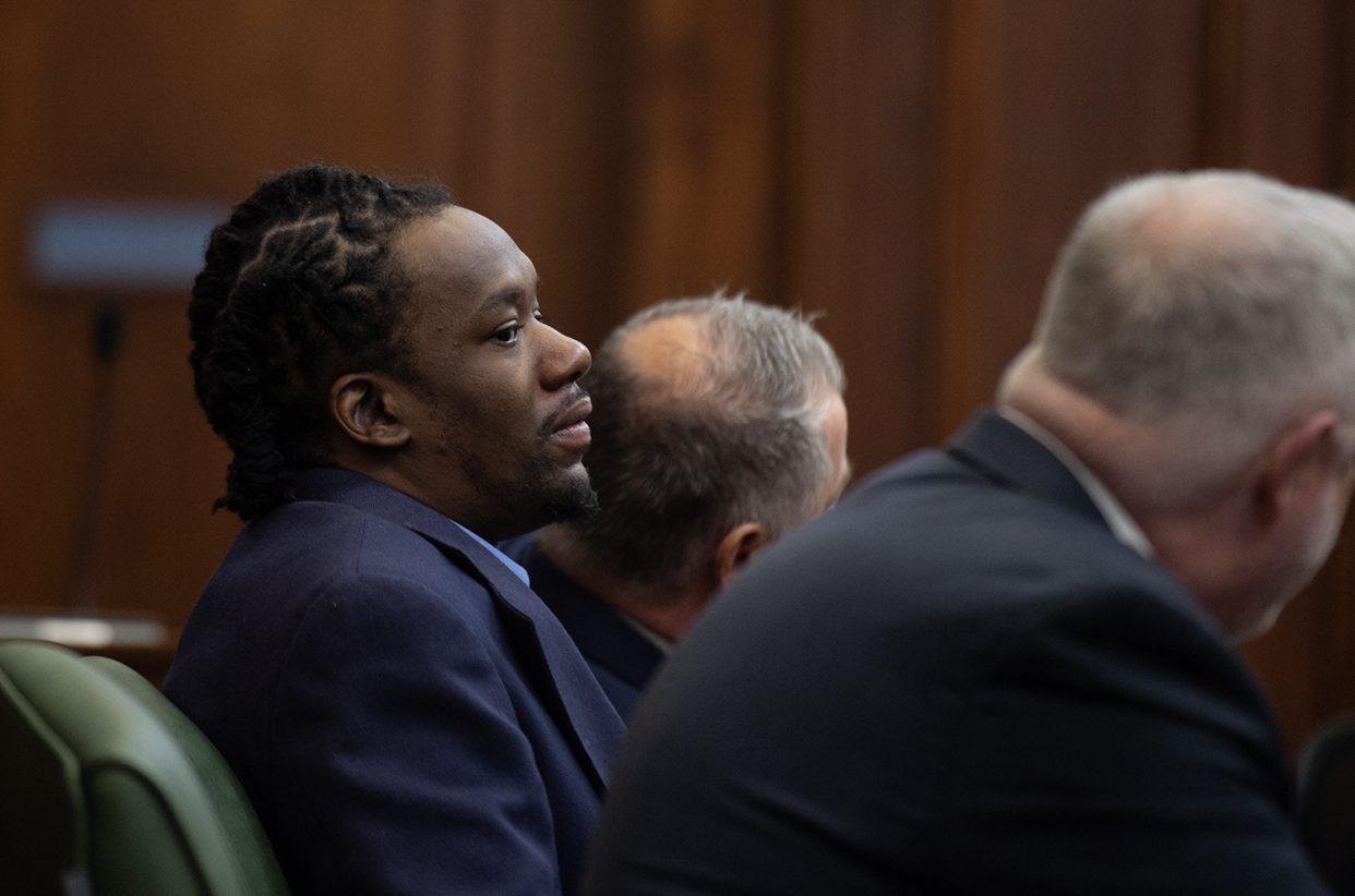 Leon Newsome sits back as his attorneys, Nathan Ray and John Greven, talk to Judge Tammy O'Brien after a jury could not reach a verdict  Wednesday in Summit County Common Pleas Court.