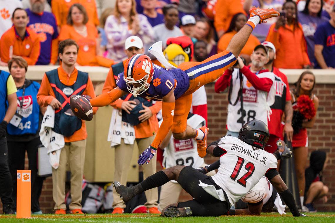 Clemson wide receiver Antonio Williams (0) dives with the ball over Louisville cornerback Jarvis Brownlee (12) but short of the end zone in the first half of an NCAA college football game, Saturday, Nov. 12, 2022, in Clemson, S.C. (AP Photo/Jacob Kupferman)