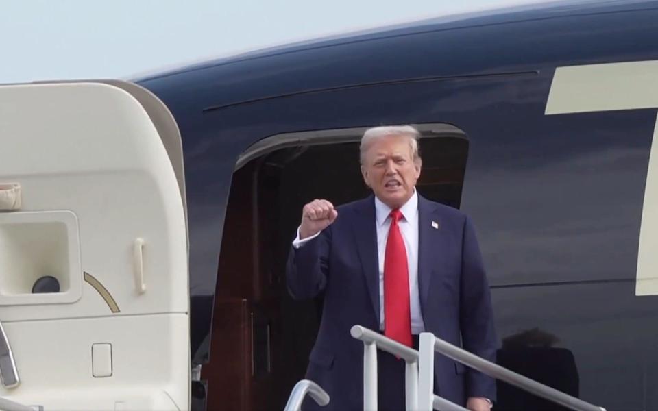 Donald Trump emerges from his Boeing 757 after landing in Atlanta