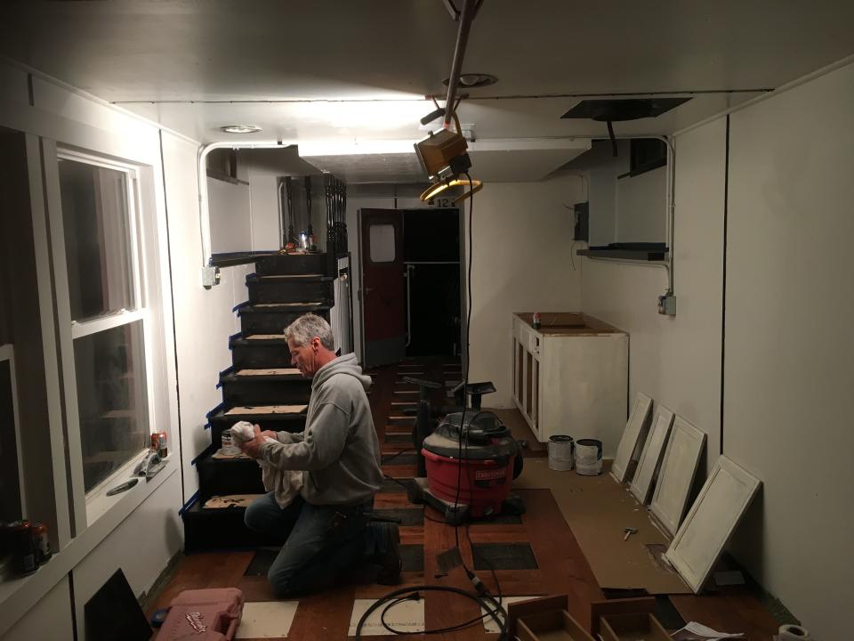 Jim Dotzenrod working inside the 1973 train caboose in Iowa.