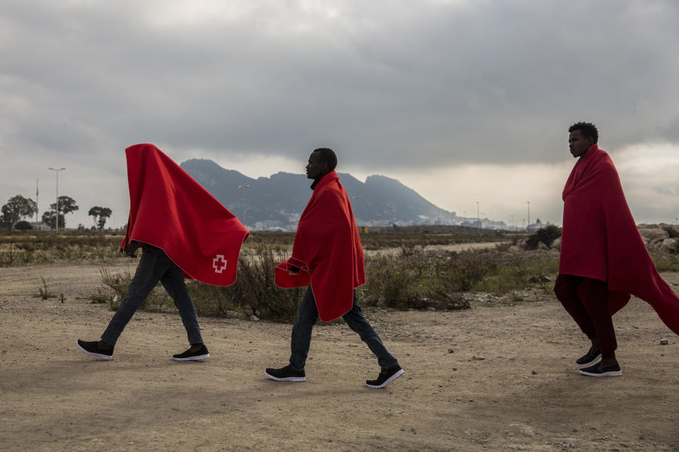 Migrants disembark from the Spanish NGO Proactiva Open Arms rescue vessel, after being rescued Dec. 21, in the Central Mediterranean Sea, before disembarking in the port of Crinavis in Algeciras, Spain, Friday, Dec. 28, 2018. The Proactiva Open Arms aid boat carrying over 300 migrants rescued at sea, has ended a weeklong journey across the western Mediterranean Sea to dock at the Spanish port of Algeciras on Friday. (AP Photo/Olmo Calvo)