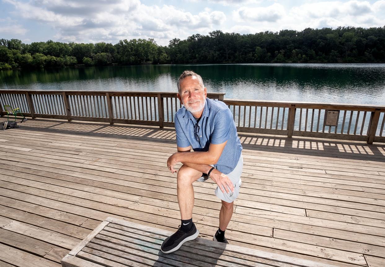 Darris Blackford, race director for the Columbus Marathon, stands near the entrance to the Antrim Park Loop trail. Blackford visits the loop often and was married on the dock nearby.