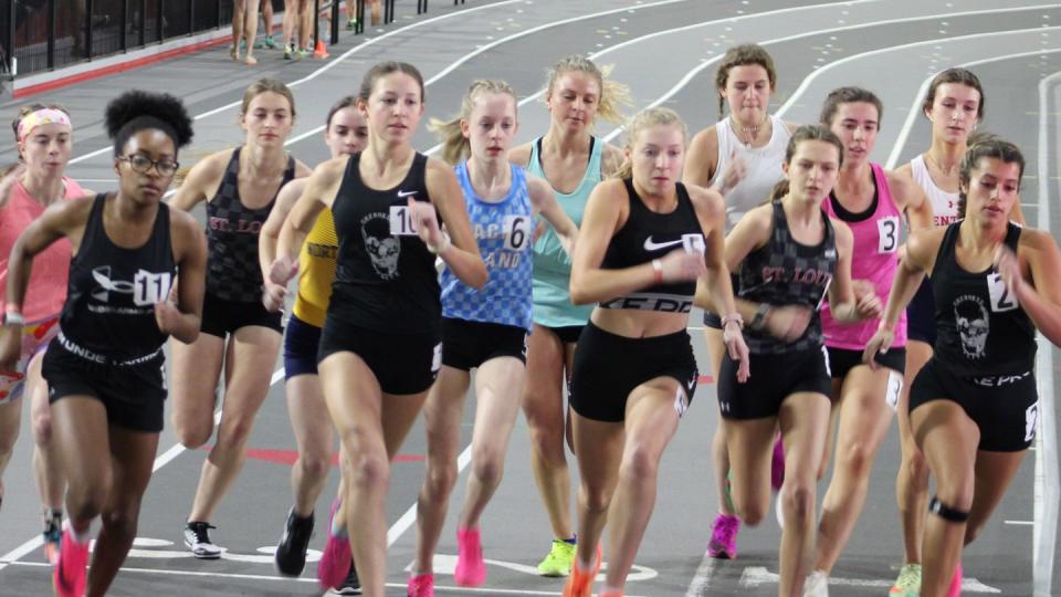 a group of people running on a track