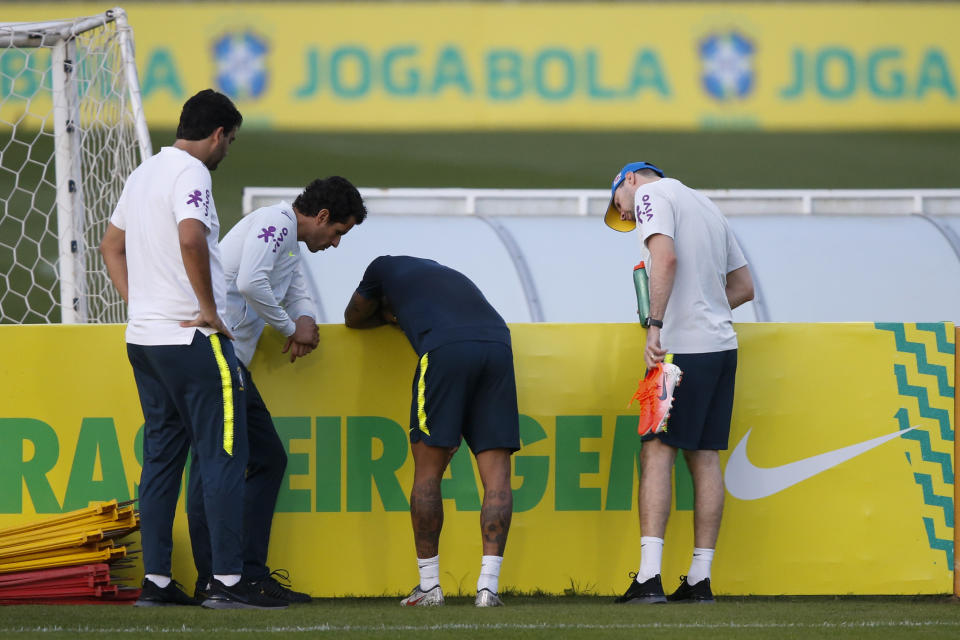 Brazil's soccer player Neymar leans against a banner during a practice session at the Granja Comary training center aheadof the Copa America tournament in Teresopolis, Brazil, Tuesday, May 28, 2019. (AP Photo/Leo Correa)