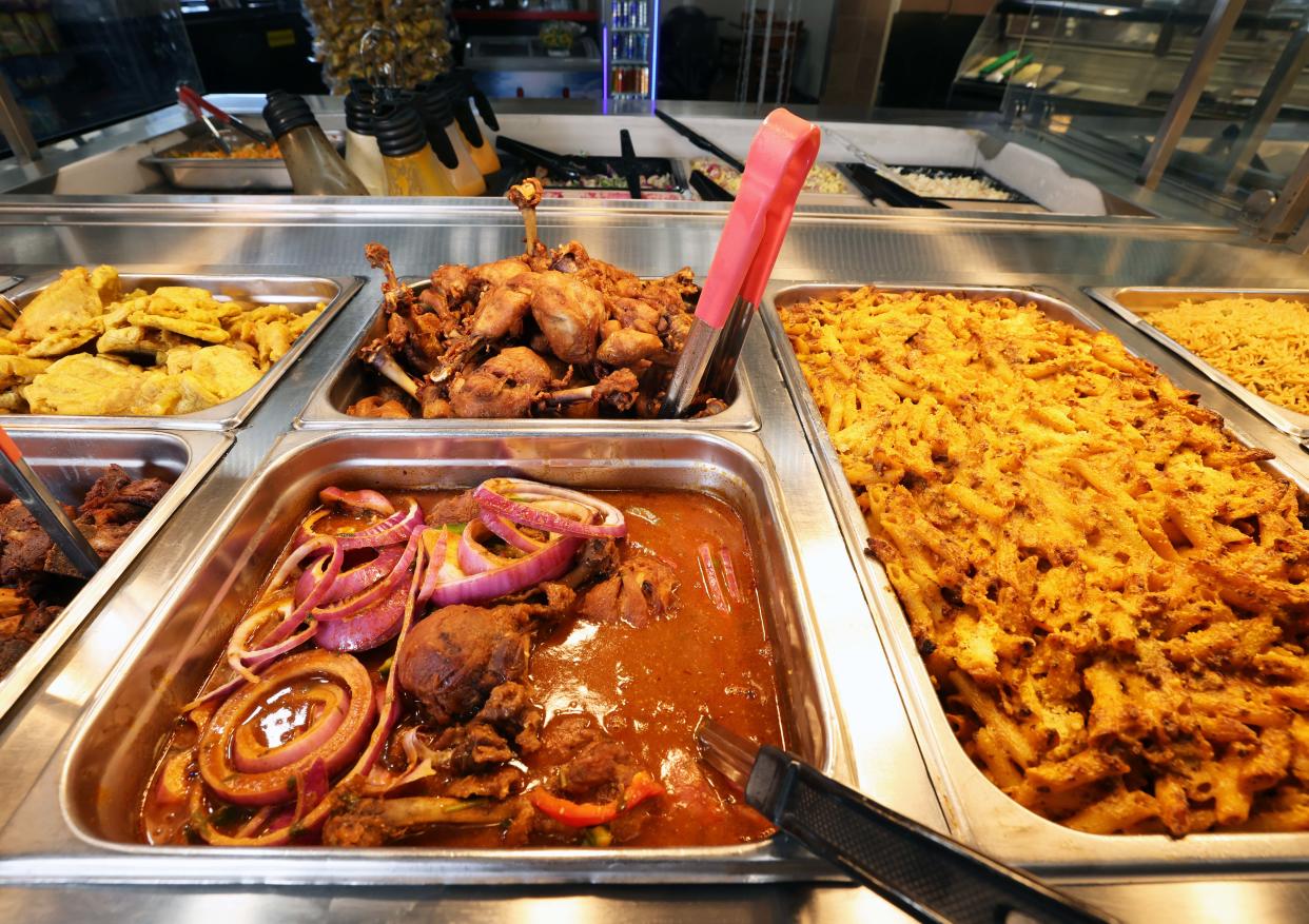 Chef Mirbentz Jean Francois of Brockton sells hot, prepared authentic Haitian food at America's Food Basket in Randolph on Tuesday, April 9, 2024.
