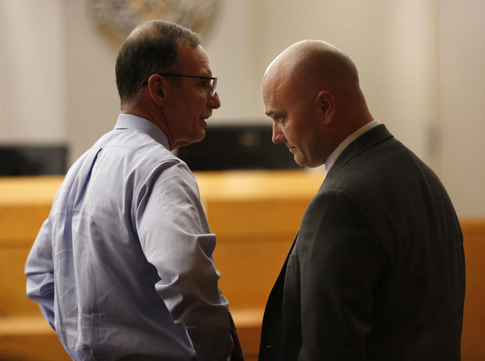 Defendant Roy Oliver, right, a fired Balch Springs police officer charged with the murder of 15-year-old Jordan Edwards, and his defense attorney Bob Gill speak after seeing a question from the jury indicating they can't reach a unanimous verdict during a trial of Oliver at the Frank Crowley Courts Building in Dallas on Tuesday, Aug. 28, 2018. Oliver was convicted of murder on Tuesday for fatally shooting an unarmed black teenager when he fired into a car full of teenagers leaving a house party in suburban Dallas. (Rose Baca/The Dallas Morning News via AP, Pool)