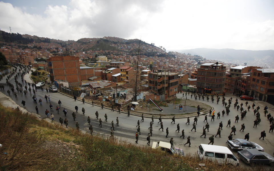 Low ranking soldiers march on the third day of protests in La Paz, Bolivia, Thursday, April 24, 2014. Enlisted soldiers are protesting the military high command's dismissal of four of its leaders who defended their call for changes so that non-commissioned officers may study to become career officers. (AP Photo/Juan Karita)