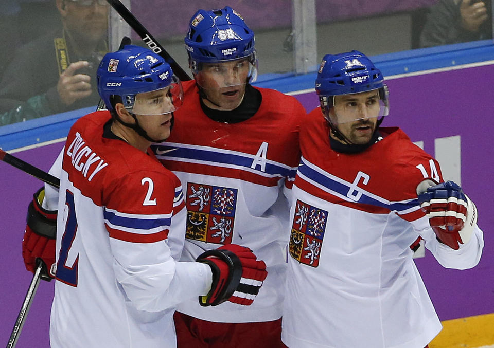 Czech Republic defenseman Marek Zidlicky, forward Jaromir Jagr and forward Tomas Plekanec celebrate after Jagr scored a goal against Sweden in the second period of a men's ice hockey game at the 2014 Winter Olympics, Wednesday, Feb. 12, 2014, in Sochi, Russia. (AP Photo/Julio Cortez)