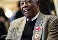 Hank Aaron smiles after being presented with the Order of the Rising Sun, Gold Rays with Rosette by the Consul General of Japan at his official residence Thursday, Jan. 14, 2016, in Atlanta. Japan has honored the former home run king with one of its highest awards, bestowing the Order of the Rising Sun for bringing young people and countries together through baseball. (AP Photo/David Goldman)