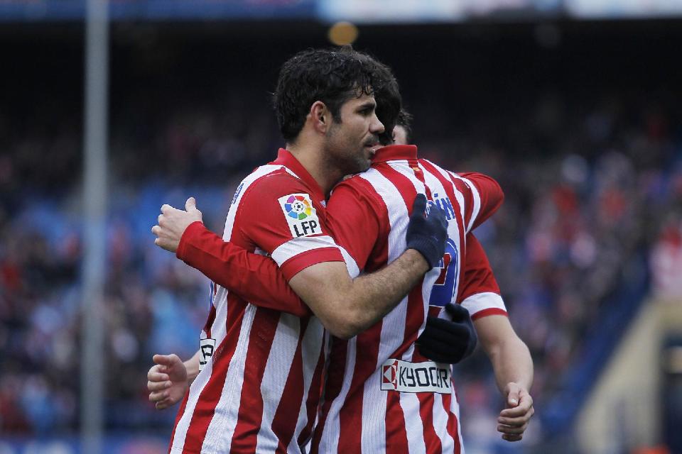 Atletico's Diego Godin, right, celebrates his goal with Diego Costa, left, during a Spanish La Liga soccer match between Atletico Madrid and Valladolid at the Vicente Calderon stadium in Madrid, Spain, Saturday, Feb. 15, 2014. (AP Photo/Gabriel Pecot)