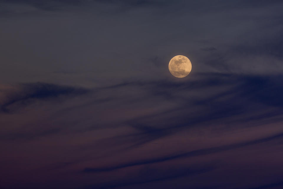 The moon rises over the Mojave Desert.