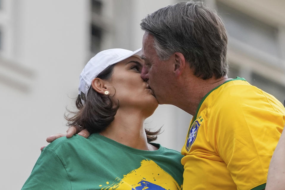 Former President Jair Bolsonaro kisses his wife Michelle during a rally organized by supporters in Sao Paulo., Brazil, Sunday, Feb. 25, 2024. Bolsonaro and some of his former top aides are under investigation into allegations they attempted plotted a coup to remove his successor, Luis Inacio Lula da Silva. (AP Photo/Andre Penner)