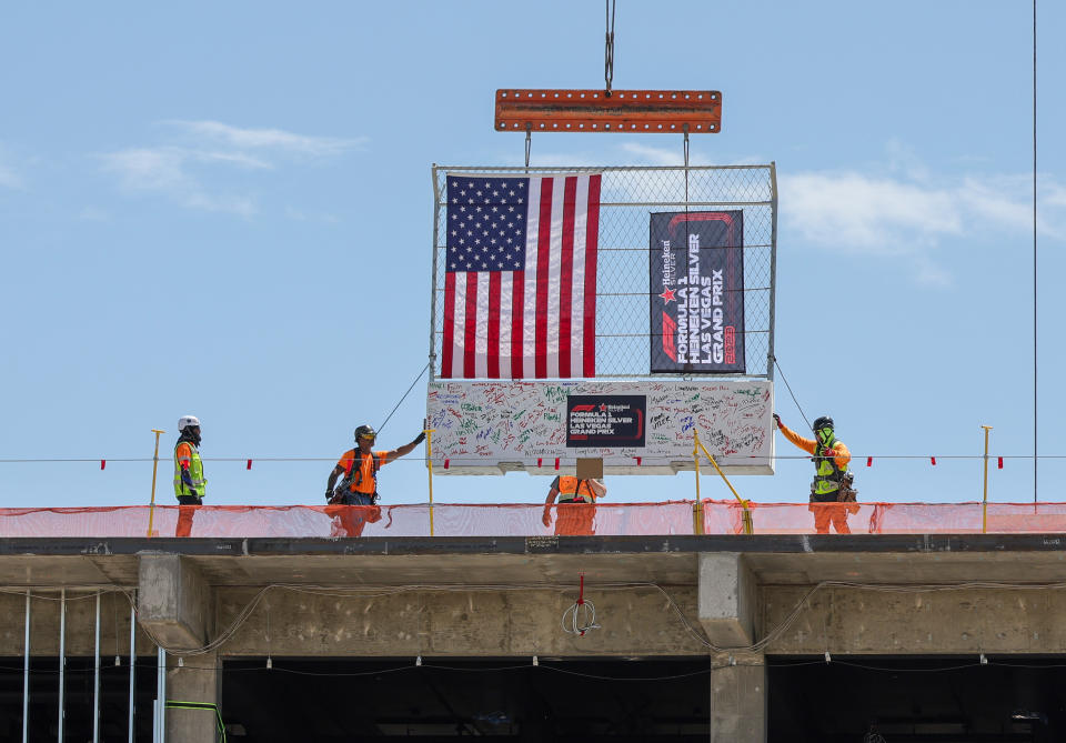 LAS VEGAS, NEVADA - 13 APRILE: Gli operai edili posizionano una barriera di sicurezza firmata dai dirigenti in cima all'edificio del paddock del Gran Premio di Las Vegas durante l'evento Top Out del 13 aprile 2023 a Las Vegas, Nevada.  Il weekend di gara inaugurale del Gran Premio di Formula 1 di Las Vegas è previsto per il 16-18 novembre 2023, con le gare che inizieranno la notte del 18 novembre.  (Foto di Ethan Miller/Getty Images)