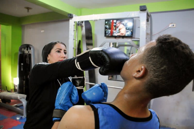 Sabah Saqr, an Egyptian boxing coach challenges social boundaries by training men, is seen during a training session at the gym, in Bani Swief