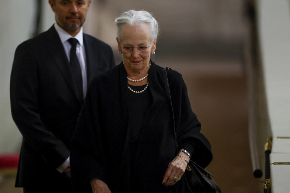 FILE - Denmark's Queen Margrethe pays her respect to the coffin of Britain's Queen Elizabeth, following her death, during her lying-in-state at Westminster Hall, in London, Sunday Sept. 18, 2022. Denmark’s Queen Margrethe II has tested positive for the coronavirus after attending the funeral of Britain’s Queen Elizabeth II. The Danish royal palace said Wednesday, Sept. 21, 2022 that the 82-year-old Margrethe canceled her official duties after the Tuesday night test. she previously tested positive for the virus in February. (John Sibley/Pool via AP, File)