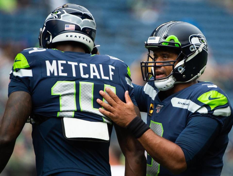 Seattle Seahawks quarterback Russell Wilson (3) greets Seattle Seahawks wide receiver D.K. Metcalf (14) during warmups. The Seattle Seahawks played the Cincinnati Bengals in an NFL game at CenturyLink Field in Seattle, Wash., on Sunday, Sept. 8, 2019.
