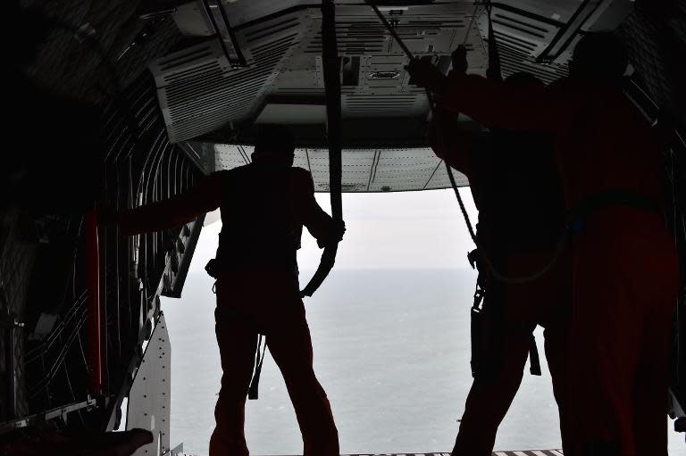 Indonesian air force CN295 crew members during the search operation for missing AirAsia flight QZ8501 over waters near Pangkalan, Central Kalimantan, on December 30, 2014
