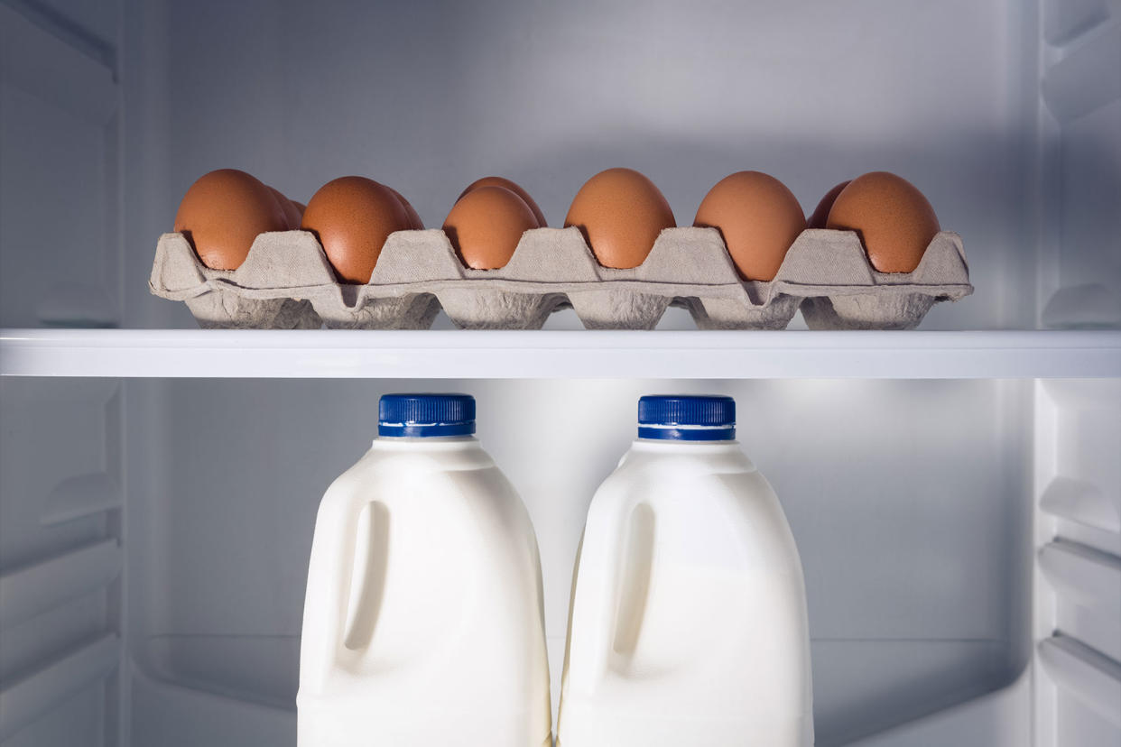 Egg carton and milk bottles in refrigerator Getty Images/Wavebreakmedia