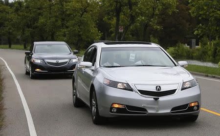 An Acura RLX sedan tows another with Honda's virtual tow technology that creates a wireless link between two cars, during a demonstration at the ITS World Congress in Detroit, Michigan, September 11, 2014. REUTERS/Rebecca Cook