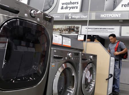 Shoppers look at washers and dryers at a Home Depot store in New York, July 29, 2010. REUTERS/Shannon Stapleton