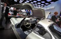 DETROIT, MI - JANUARY 11: Journalists look over a 1954 Mercedes-Benz 300SL on display during the press preview of the North American International Auto Show at the Cobo Center on January 11, 2011 in Detroit, Michigan. The show is currently opened only for media previews and opens to the general public January 15-23. (Photo by Scott Olson/Getty Images)