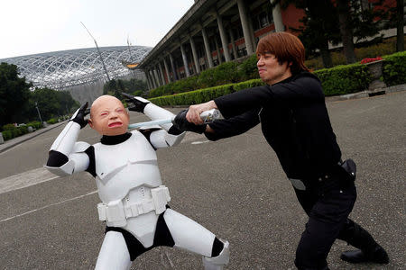 Fans dressed as the characters from "Star Wars" react during Star Wars Day in Taipei, Taiwan May 4, 2017. REUTERS/Tyrone Siu