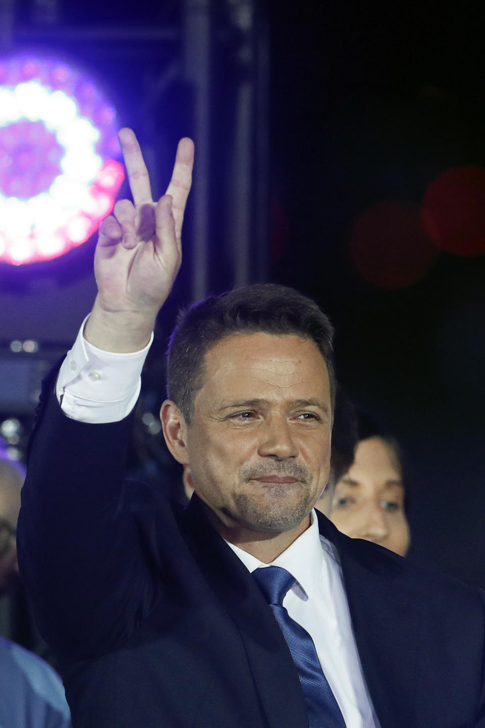 Presidential candidate Rafal Trzaskowski flashes a victory sign at the end of the election day in Warsaw, Poland, Sunday, July 12, 2020. Voting ended in Poland's razor-blade-close presidential election runoff between the conservative incumbent Andrzej Duda and liberal, pro-European Union Warsaw Mayor Rafal Trzaskowski with exit polls showing the election is too close to call. (AP Photo/Petr David Josek)