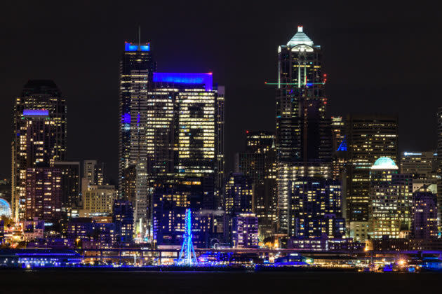 Buildings and landmarks in the Seattle skyline were turned blue in tribute to Paul Allen in November. (GeekWire Photo / Kevin Lisota) <a href="https://www.geekwire.com/2018/seattle-skyline-turns-blue-coordinated-tribute-late-microsoft-co-founder-paul-allen/" rel="nofollow noopener" target="_blank" data-ylk="slk:Read the story.;elm:context_link;itc:0;sec:content-canvas" class="link "><strong>Read the story.</strong></a>