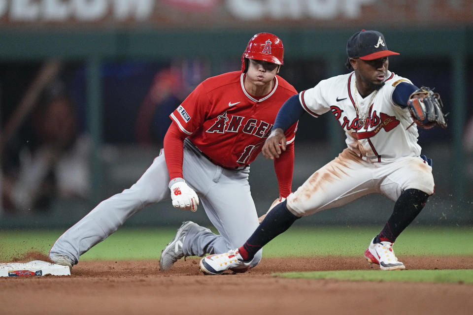 Los Angeles Angels' Shohei Ohtani steals second base as Atlanta Braves second baseman Ozzie Albies handles the late throw in the sixth inning of a baseball game, Tuesday, Aug. 1, 2023, in Atlanta. (AP Photo/John Bazemore)