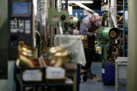 A worker forms the bell of a saxophone at the Henri Selmer wind instruments factory in Mantes-la-Ville near Paris, France, January 17, 2018. REUTERS/Benoit Tessier