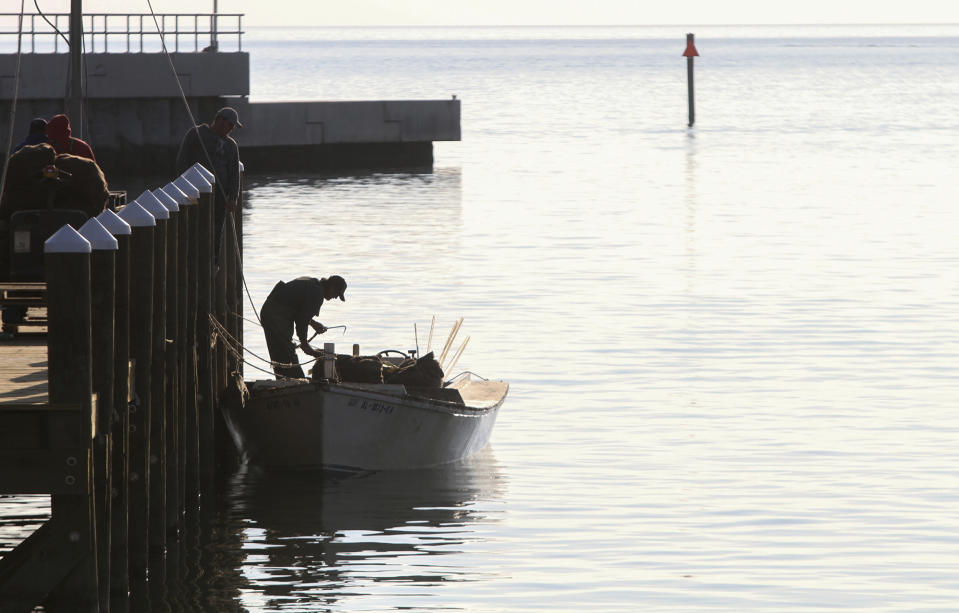 FILE In this Dec. 12, 2014, file photo a fisherman unloads his catch of oysters at the new Pass Christian Harbor, Miss. Mississippi's governor wants the federal government to declare a fisheries disaster as freshwater from a Mississippi River spillway gushes into what's normally a partly salty estuary, killing countless oysters and crabs. (Amanda McCoy/The Sun Herald via AP, File)