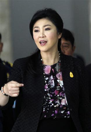 Thailand's Prime Minister Yingluck Shinawatra gestures as she leaves the Royal Thai Air Force Headquarters, after a cabinet meeting in Bangkok January 23, 2014. REUTERS/Chaiwat Subprasom