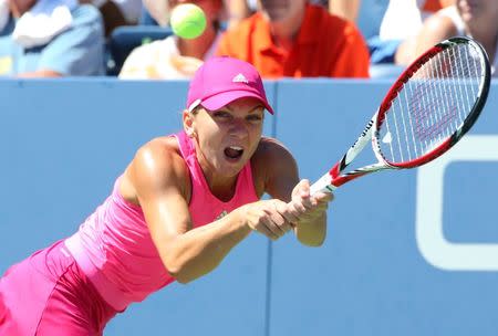 Simona Halep (ROU) returns a shot to Mirjana Lucic-Baroni (CRO) on the Grandstand Court on day five of the 2014 U.S. Open tennis tournament at USTA Billie Jean King National Tennis Center. Mandatory Credit: Anthony Gruppuso-USA TODAY