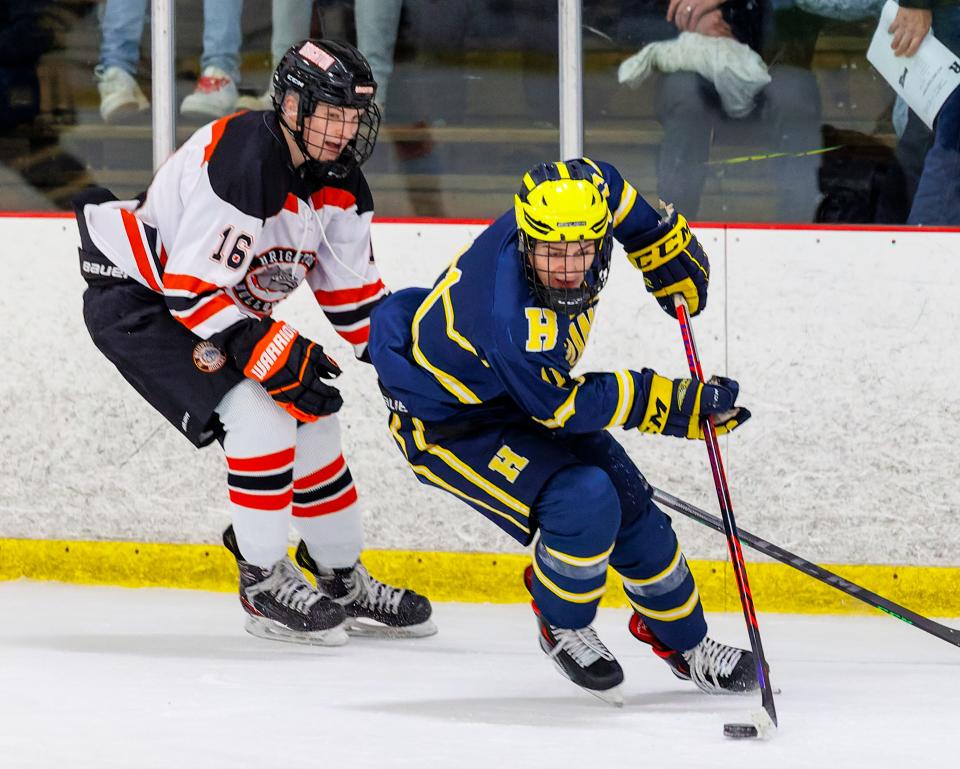 Hartland's Ben Pouliot (right) and Brighton's Cameron Duffany (16) could meet in the regional hockey tournament next winter following a change in how the MHSAA classifies teams.