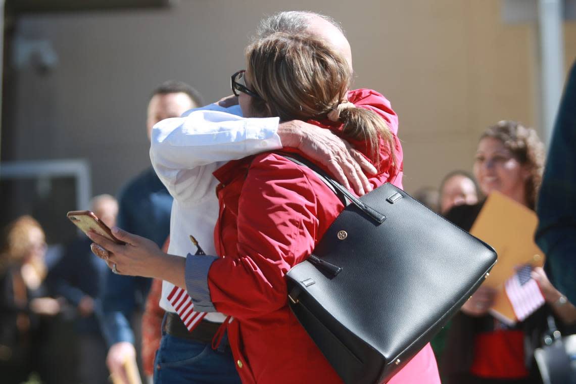 Mercedes Márquez hugs her father José Guadalupe Muro Viramontes who became a US citizen Thursday (Sept. 22) at the offices of the United States Citizenship and Immigration Services in Fresno.